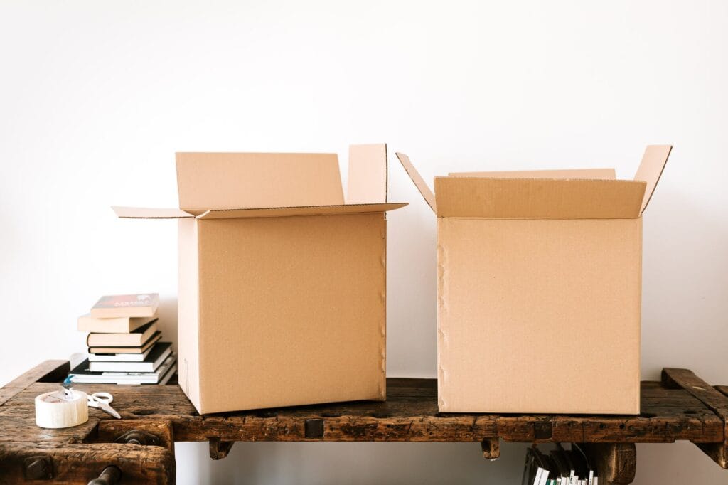 carton boxes and stacked books on table